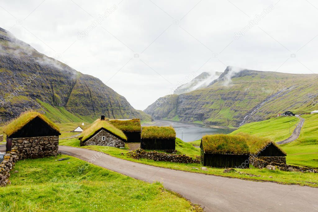 Breathtaking Faroe islands scenery with traditional grass roof houses in village of Saksun