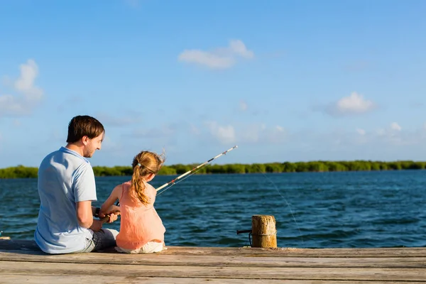 家庭父亲和女儿一起在木制码头钓鱼 — 图库照片