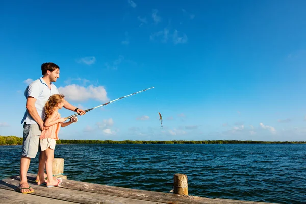 家庭父亲和女儿一起在木制码头钓鱼 — 图库照片