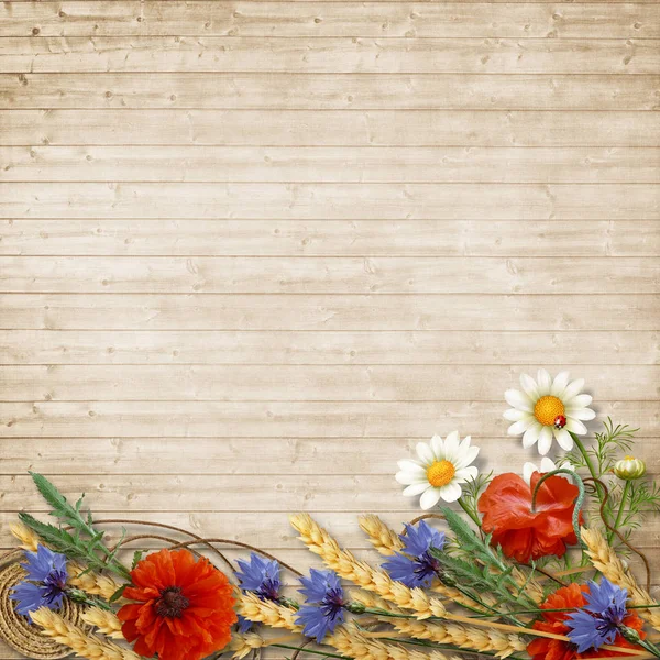 Wild flowers with spikelets on a wooden background — Stock Photo, Image