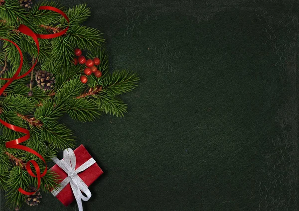 Рождественские вечнозеленые ветви и ягоды на старинном темном фоне — стоковое фото