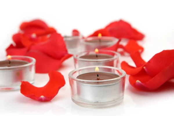 Rose petals and candles on a white background — Stock Photo, Image
