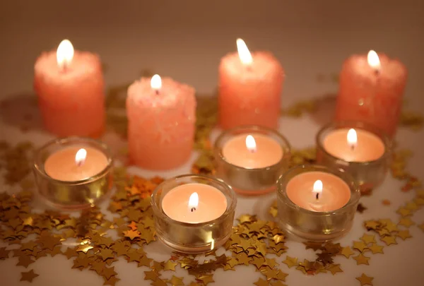 Burning candles and confetti — Stock Photo, Image