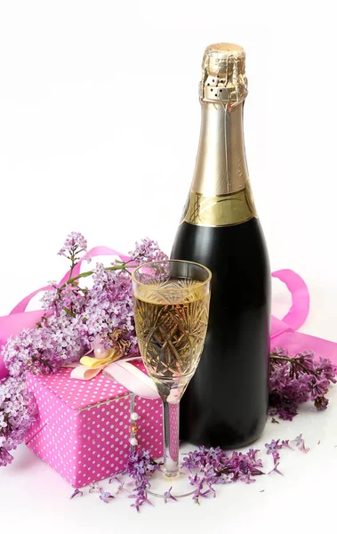 Una rama de lila y una botella de champán —  Fotos de Stock