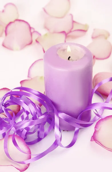 Rose petals, ribbon and burning candles — Stock Photo, Image