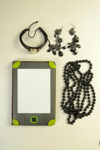 E-book, watch, ear rings and necklace — Stock Photo, Image