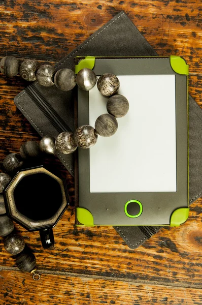 Cup of coffee ,necklace, tablet and note book — Stock Photo, Image