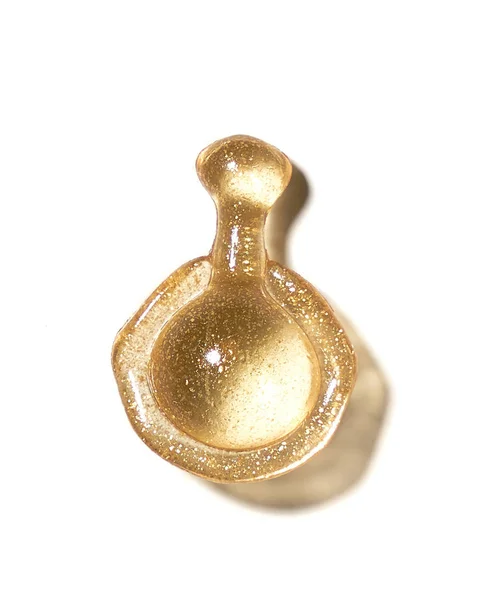 Golden capsule with cosmetic oil — Stock Photo, Image