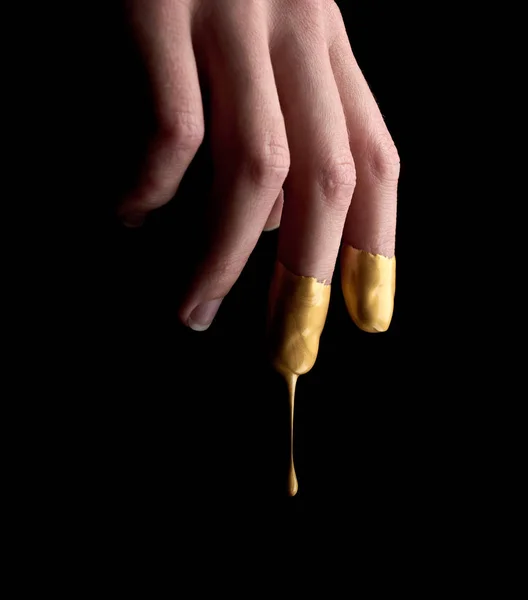 Female hand in liquid gold — Stock Photo, Image