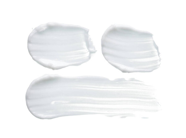 White texture and smear of face cream or white acrylic paint isolated on white background