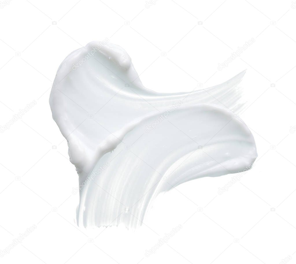 White texture and smear of face cream or white acrylic paint isolated on white background