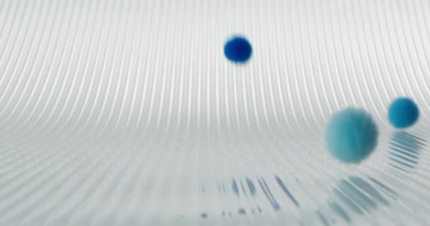 Boules molles multicolores tombantes et roulantes de différentes tailles sur un fond clair 