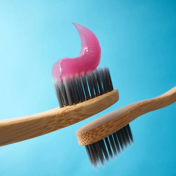 Pink Toothpaste Natural Bamboo Toothbrush Black Charcoal Bristles Blue Background — Stock Photo, Image