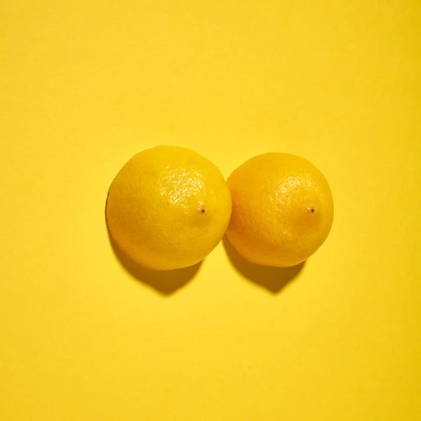 Two Yellow Lemons Bright Yellow Background Imitation Beautiful Female Breast — Stock Photo, Image