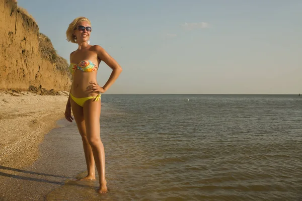 Schöne Frau im Bikini entspannt am Strand — Stockfoto