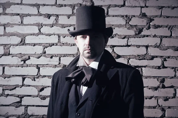 Victorian man in the black coat, top hat and in a tie — Stock Photo, Image