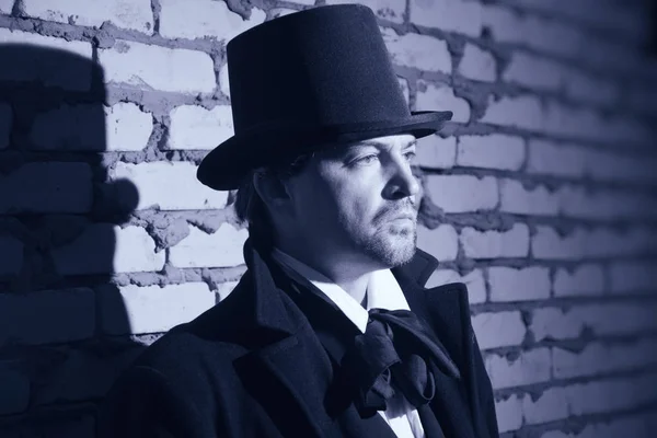 Victorian man in the black coat, top hat and in a tie — Stock Photo, Image