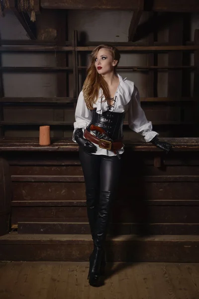 Fashion portrait of woman in pirate style at tavern — Stock Photo, Image