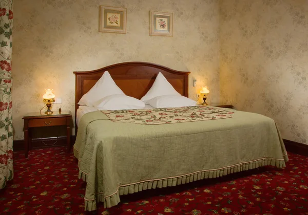 Interior of the bedroom with a vintage bed — Stock Photo, Image