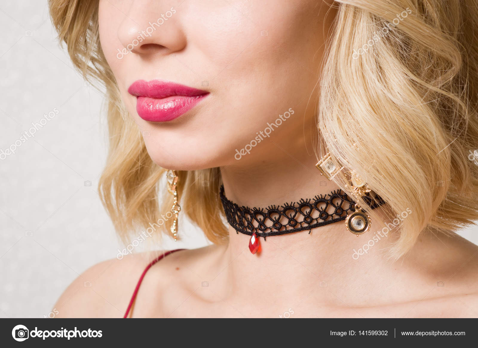 Beautiful woman showing her neck with a choker on it Stock Photo by