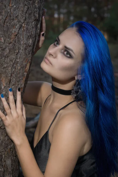 Belle femme aux cheveux bleu foncé habillée en robe noire en th — Photo