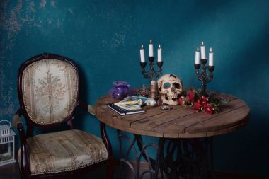 Mystic still life with skull, tarot cards, books and candles