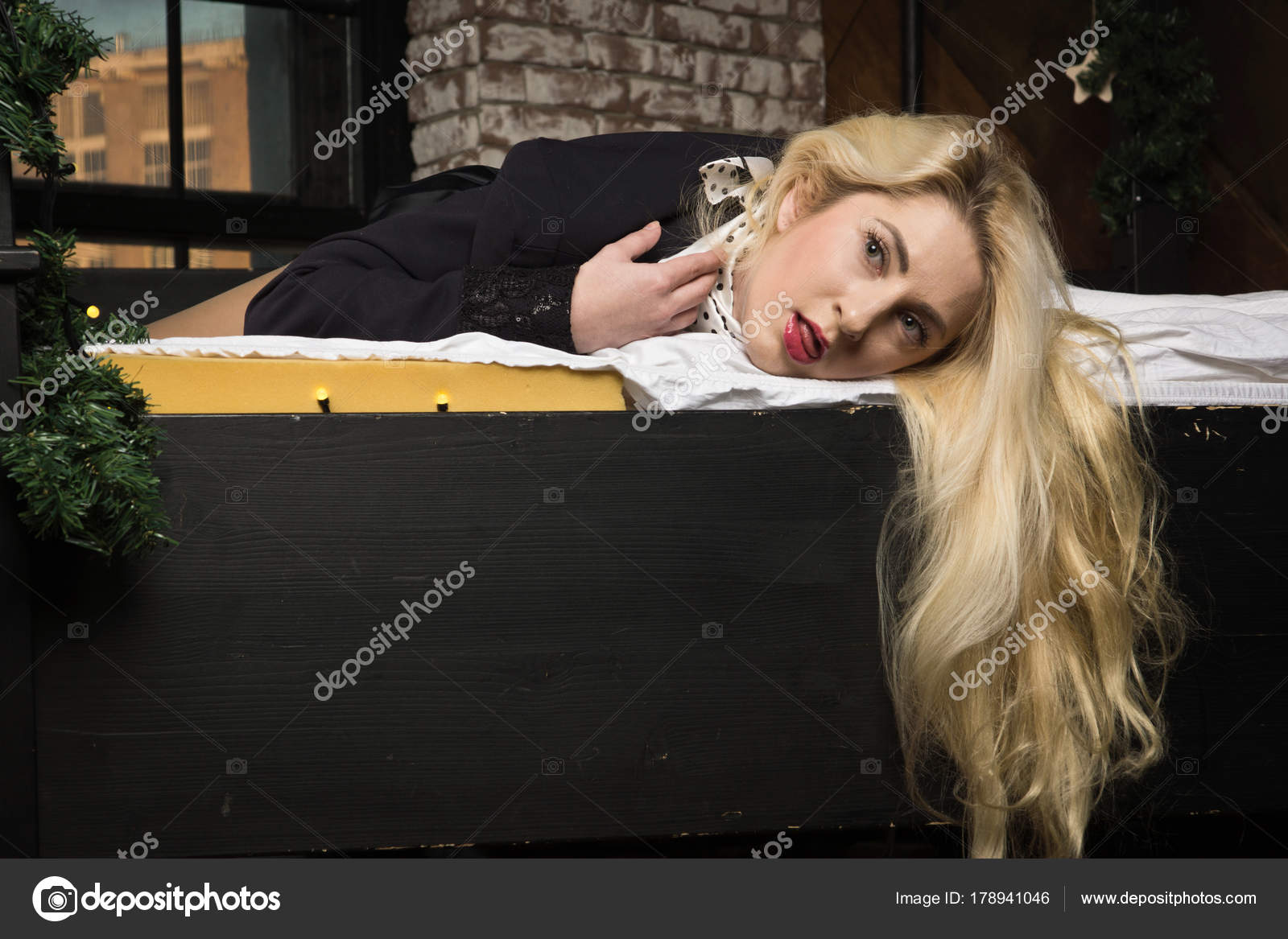Strangled business woman lying on the bed - Stock Image. 