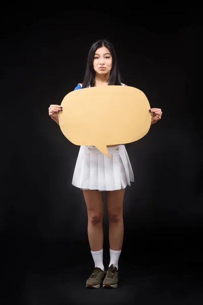 Asian woman posing with blank poster in studio — Stock Photo, Image