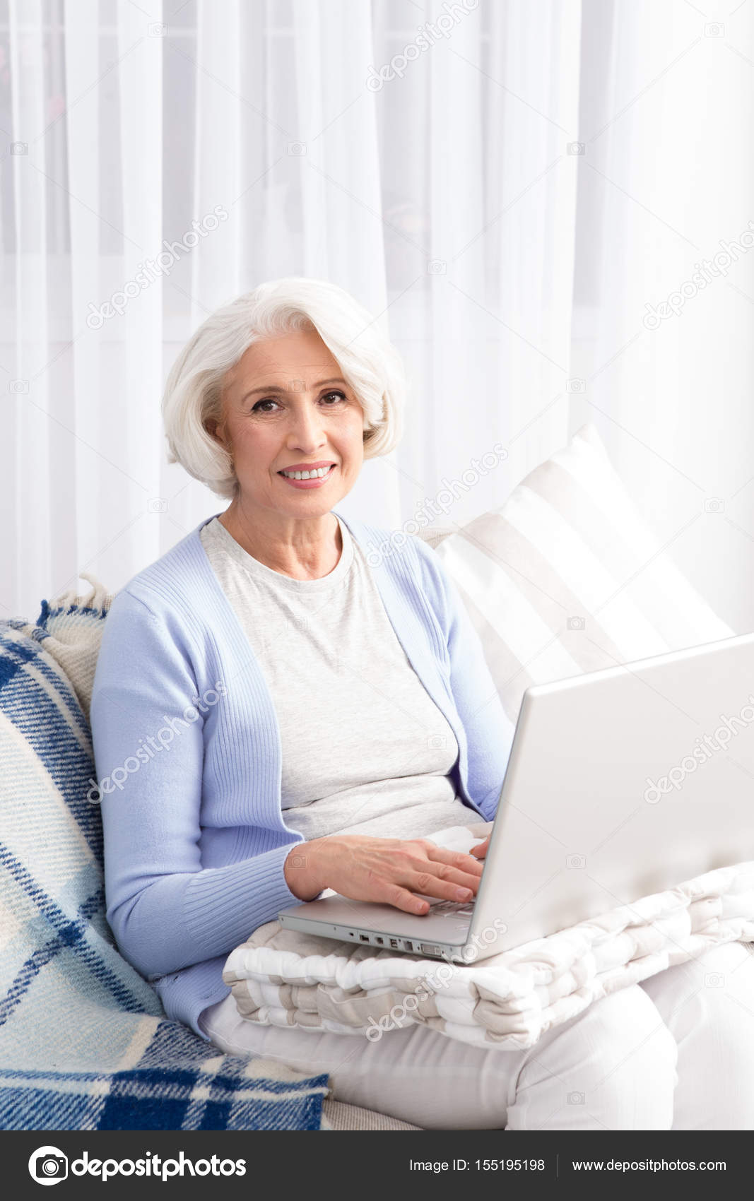 Grandmother using laptop computer Stock Photo by ©svyatoslavlipik 155195198