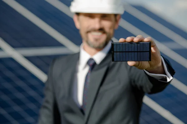 Close up view on photovoltaic element in hand of busines client. — Stock Photo, Image