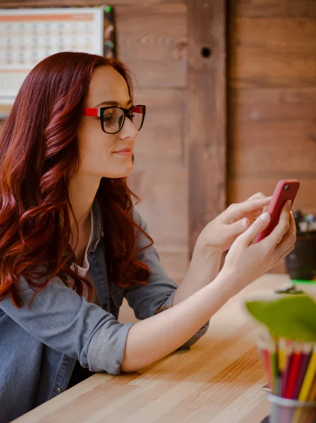 Side view of ginger haired freelance female. — Stock Photo, Image