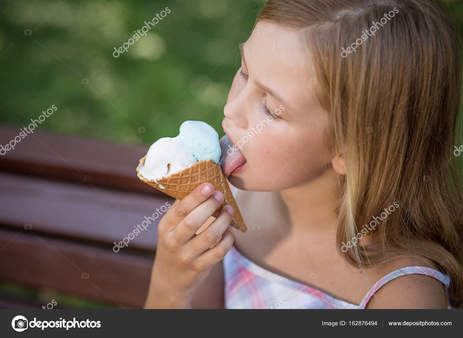 10. Little girl with blond hair and a big smile eating ice cream - wide 5
