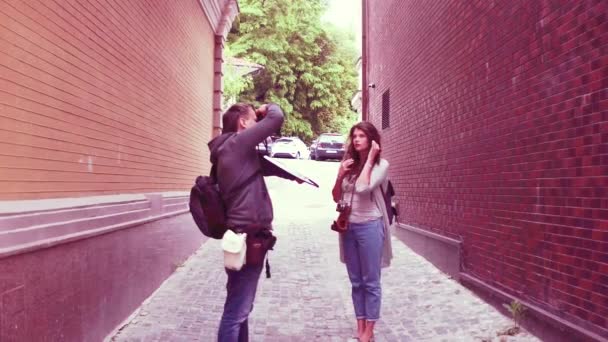 Chica turística posando para camarógrafo en la pequeña calle . — Vídeos de Stock