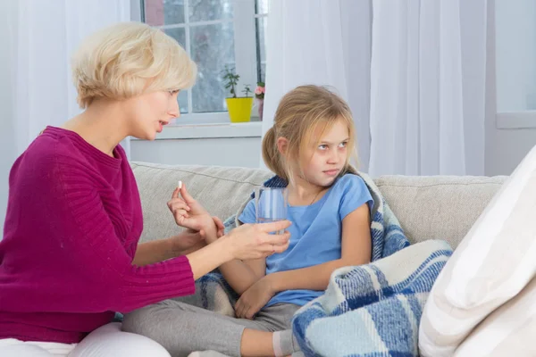 Mutter gibt ihrem kranken Kind Medikamente. — Stockfoto