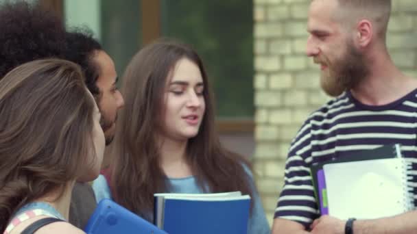 Close up view of students talking in front of university. — Stock Video