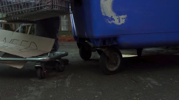 View of tramp rummaging in trash can. — Stock Video