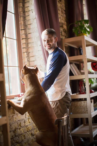 Los verdaderos amigos, el hombre y su perro pasar tiempo en casa . — Foto de Stock