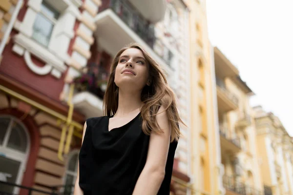 Vue du bas de la jeune belle femme dans la rue de la ville . — Photo