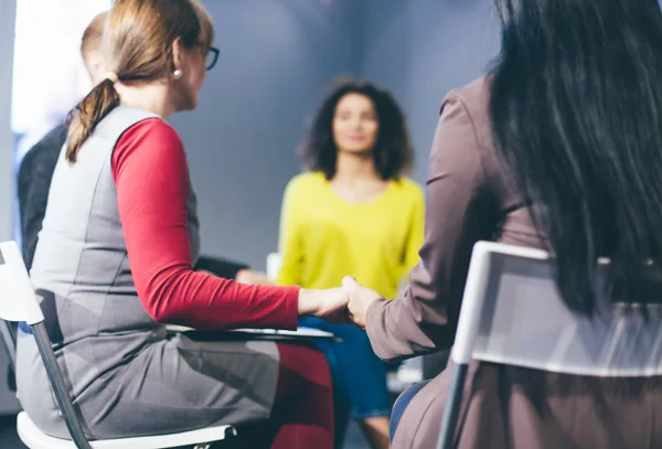 Group therapy session sitting in a circle