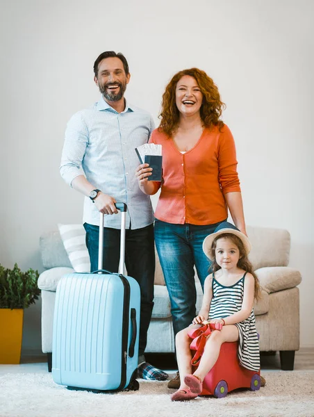 Family travel, happy couple and daughter setting off on journey.