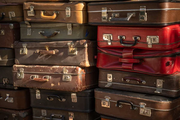 Aged weathered leather suitcases on top of eachother — Stock fotografie