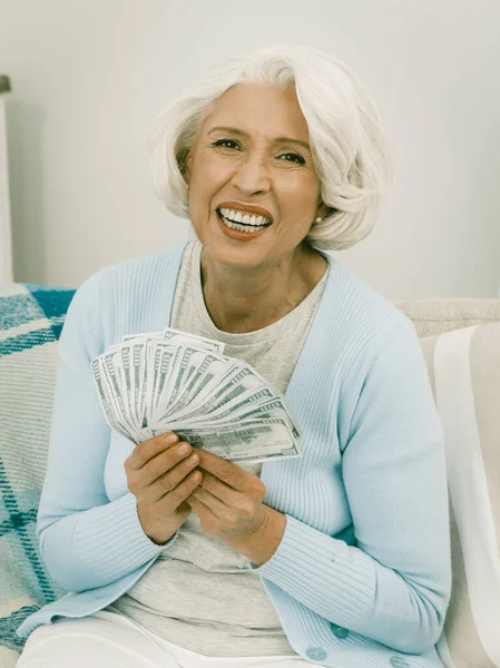 Senior Woman Laughs Holding A Fan Of Money — Stock fotografie