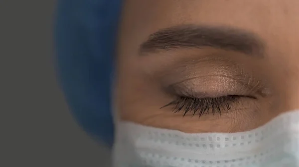 Closed Eye Of Female Doctor In Protective Mask, Close Up