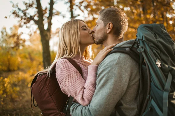 Kyss av unga par i höstskogen — Stockfoto