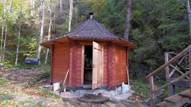 Houten hutkeuken aan beekje in een rustig donker bos — Stockvideo