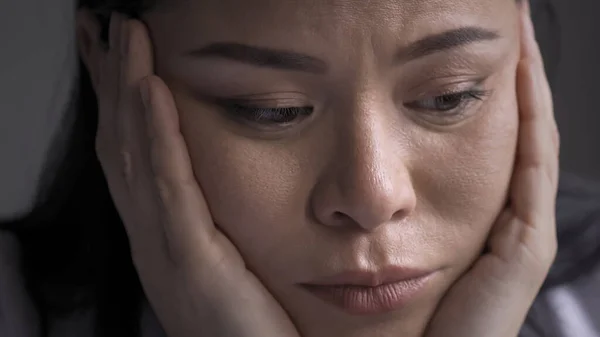 Gros plan du médecin fatigué fase somnolent posé sur ses mains. Somnolent femme asiatique surchargée a appuyé sa tête sur les mains en regardant le côté. Malheureux Medic ressent du stress après de longues heures supplémentaires. Concept pandémique — Photo