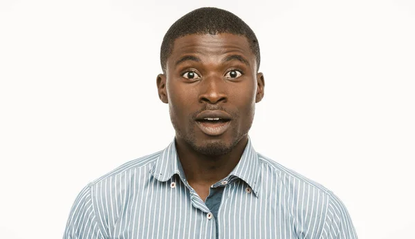 Surprised Afro-American businessman. Young Amazed man looks at camera with opened mouth and astonished eyes. Cut out portrait on white background — Stock Photo, Image