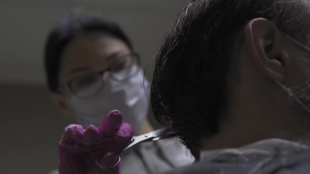 Κομμωτήριο σε defocus κόβει τα μαλλιά ενός άνδρα στο σπίτι κατά τη διάρκεια της περιόδου καραντίνας του coronavirus, φακός εστίαση στον άνθρωπο. Κοντινό πλάνο. Επιλεκτική εστίαση. Κομμωτήριο. Πρότυπα 422 — Αρχείο Βίντεο
