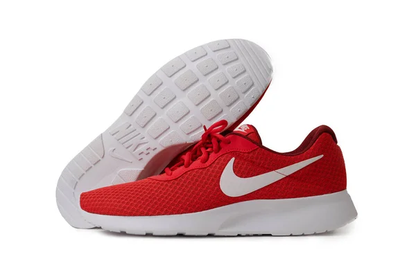 Red Nike brand sneakers. Lightweight reticulate shoes for jogging and walking. Popular modern model for fitness and running. Shoes isolated on color background. Lifestyle concept. May, 2019. Kiev — Stock Photo, Image