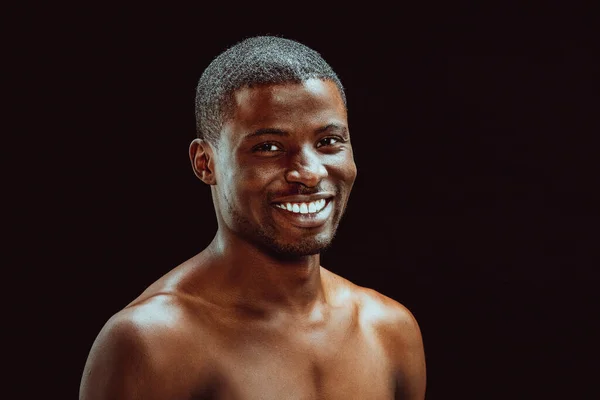 Nude afro american man with an excellent white-toothed smile looking at camera. Cut out on black background. Healthy teeth concept. Dental care concept. Toned image — Stock Photo, Image